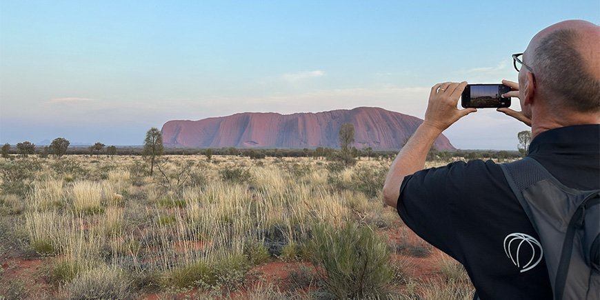 Mies ottaa kuvan Ulurusta Australiassa.